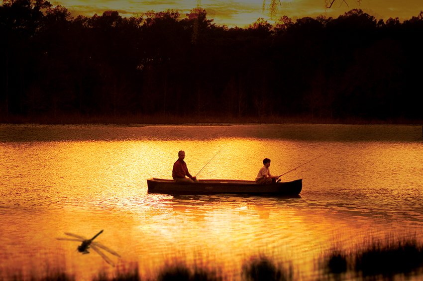 Men on a canoe on Lake Jackson at Sunset