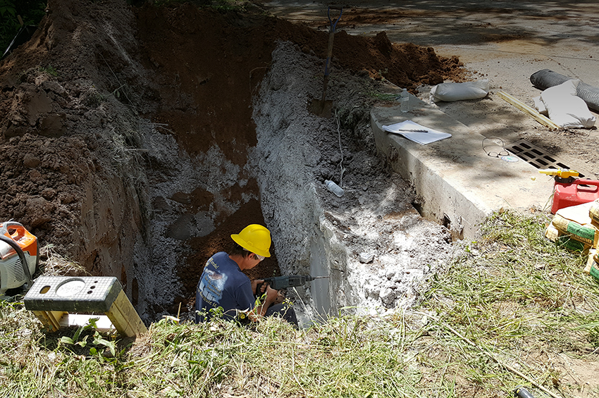 County staff making repairs to a storwater system 